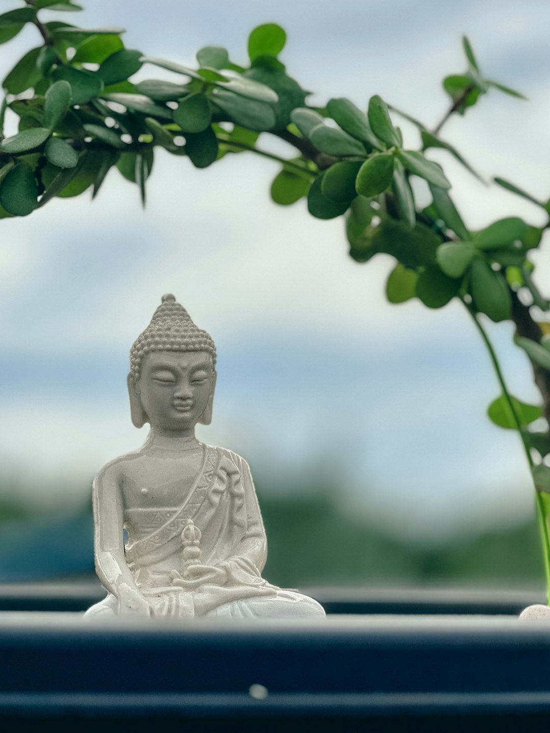 White buddha statue with blue sky background